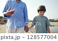 Joyful Moments of a Loving Child and Parent Strolling Together in Natures Embrace 128577004