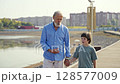 Warm and Cherished Moments A Grandfather and His Grandson Strolling by the Waters Edge 128577009