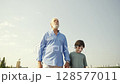 Joyful and Heartwarming Moments Grandfather and Grandson Happily Walking Together 128577011
