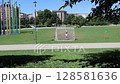 Children playing football in a public park in Milan, Italy 128581636