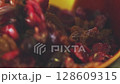 Mixing Raisins and Dried Cranberries with Spoon Macro Shot 128609315