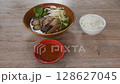 boiled braised beef meat and tendon couple organ in herb brown soup on bowl dipping spicy chili sauce eat couple with plain rice 128627045