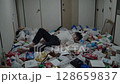 A young man sleeping soundly in a dirty room 128659837