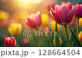 Lush spring flowers bloom with vibrant colors, basking in the soft, warm light of a golden spring sunrise, showcasing natural beauty with summer evening or morning. 128664504