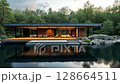 Modern house on a lake with a forest in the background. concept of ecological house keeping and luxury real estate, nature retreats, sustainable living, and tranquil, harmonious lifestyle. 128664511