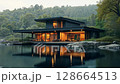 Modern house on a lake with a forest in the background. concept of ecological house keeping and luxury real estate, nature retreats, sustainable living, and tranquil, harmonious lifestyle. 128664513