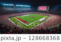 night football game at stadium with packed stands 128668368