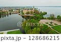 Cinematic view of Schwerin Castle in Germany, highlighting elegant architecture surrounded by sparkling lakes and green scenery 128686215
