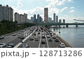 High-rise buildings and cars running on motorways in Yeouido, the financial hub, filmed during the summer day on the Han River Bridge in Seoul 128713286