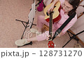 High angle of young woman guitarist expression playing acoustic classical guitar with strumming style. Caucasian female guitar player is taking practice in home music studio. Handheld, selective focus 128731270