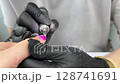 Manicure care procedure. Cleaning the nail of the hand with a milling machine. Hardware combined manicure. Fraser is in the hands of a manicurist. Preparation of the nail plate. Removal of the 128741691