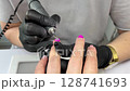 Close Up Manicure in Nail Salon. Nail Care. Cleaning Cuticle. female hand 128741693