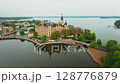 Panoramic view of Schwerin Castle in Germany, showcasing its grand towers, lakeside setting, and beautiful landscaped grounds. Ideal for tourism and architecture footage. 128776879