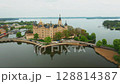 Aerial view of Schwerin Castle reveals its island setting amid tranquil lakes and lush parklands. Magical German landmark. 128814387