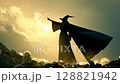 Mystical Wizard Casting Spell at Sunset with Backlit 128821942