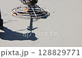 Concrete slab finishing tools smooth new cement surface at construction site under works day 128829771