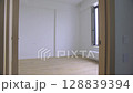 The camera effortlessly glides through the doorway, revealing a bright and vacant space. 128839394