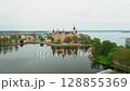 Panorama of Schwerin Castle captures ornate towers, serene water, and vibrant gardens. Perfect historic travel footage.  128855369