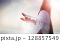 Jesus Christ extending his hand of salvation, the resurrected Jesus leading us into heaven with arms outstretched, Easter background, looping video 128857549