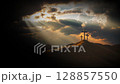 The majestic sky, clouds and light of Golgotha Hill, with the Holy Cross symbolizing the death and resurrection of Jesus Christ in the background 128857550