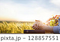 Christian praying in a barley field with autumn fruits and a bible, Thanksgiving and Thanksgiving background, looping video 128857551