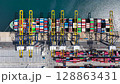 4k, Time lapse, Aerial view container ship carrying container in import export business logistic and transportation of international by container ship in the open sea. 128863431