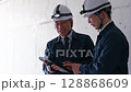 A meeting between a young worker and a veteran worker 128868609