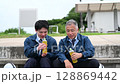 A young construction manager and a veteran construction manager drinking tea 128869442
