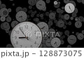 Multiple clocks with fast-spinning hands fly chaotically toward the camera in a time-lapse. Concept of the rapid, uncontrollable passage of time and urgency, deadlines, and time pressure 128873075