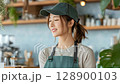 A young woman working part-time at a fashionable cafe 128900103