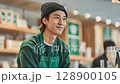 A young man working part-time at a fashionable cafe 128900105
