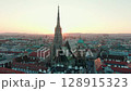 Aerial Shot of St. Stephens Cathedral in Vienna with City Rooftops on Sunset 128915323