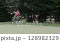 young female athlete running fast, slow motion video of running 128982329