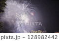 Colorful fireworks display illuminating the night sky with vibrant bursts and sparkling effects 128982442