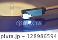 turntable with vinyl record. playing music 128986594