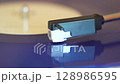 turntable with vinyl record. playing music 128986595