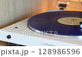 turntable with vinyl record. playing music 128986596