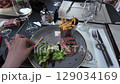 A video highlights a person enjoying a meal with fries and salad 129034169