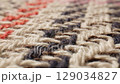 A CloseUp of a Button on a Cozy and Inviting Textile Material with Unique Patterns 129034827