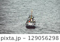 tugboat vessel is swinging on the water 129056298