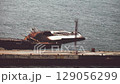 The old ship capsized near the pier 129056299