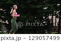 young female athlete running fast, slow motion video of running 129057499