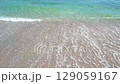 surf waves on pebble beach, slow motion 129059167