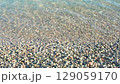 pebbles on beach and clear sea water, slow motion 129059170