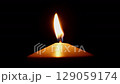 burning candle flame goes out in wind, dark background, slow motion 129059174