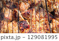 Sizzling chicken pieces grilling on a barbecue. 129081995