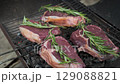 Raw Beef Steaks with Rosemary on Grill Grate 129088821