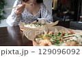 Close-up of Caucasian woman eating pan-Asian cuisine 129096092