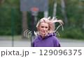 Running girl preparing for competition, race or marathon. Motivation, training for health and well-being on city streets, parks or roads. Sports, exercise, training and energy. 129096375