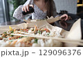 Close-up of Caucasian woman eating pan-Asian cuisine 129096376